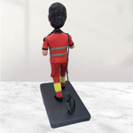 Individuelle Wackelkopffigur in roter Arbeitsuniform mit Kaffeetasse